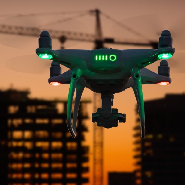 Silhouette of Drone In The Air Over Buildings Under Construction